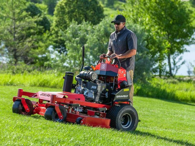 Dedicated Lawn Care with Riding Mower Man skillfully operating a riding lawn mower across a spacious yard.
